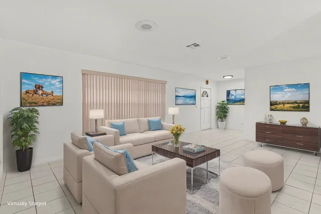 a living room with furniture and a large window