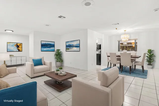 a living room with furniture and view of kitchen