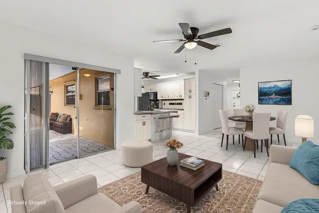 a living room with furniture a view of bedroom and a couch