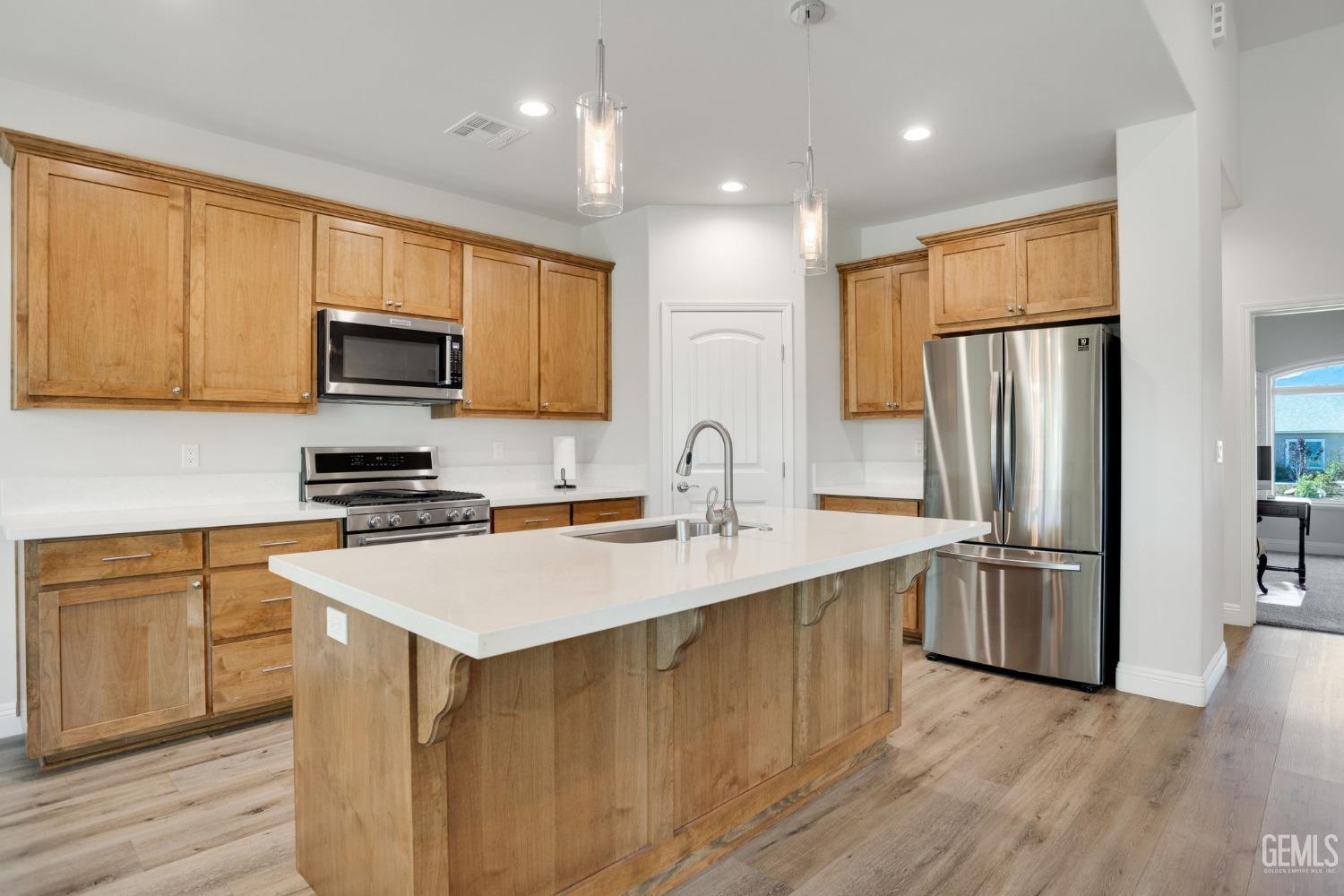 Undisclosed Address Tehachapi, CA 93561 - Photo 14 of 41 a kitchen with stainless steel appliances a refrigerator stove microwave and sink