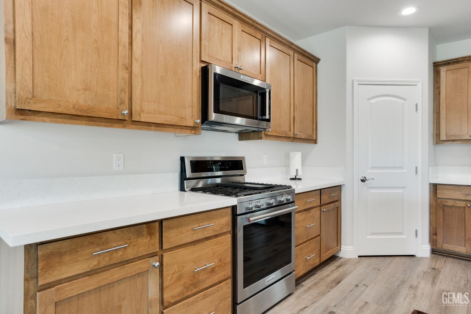 Undisclosed Address Tehachapi, CA 93561 - Photo 15 of 41 a kitchen with stainless steel appliances granite countertop a stove a sink and a microwave