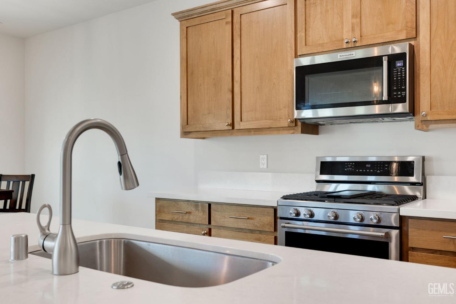 Undisclosed Address Tehachapi, CA 93561 - Photo 16 of 41 a kitchen with stainless steel appliances a stove a microwave and sink