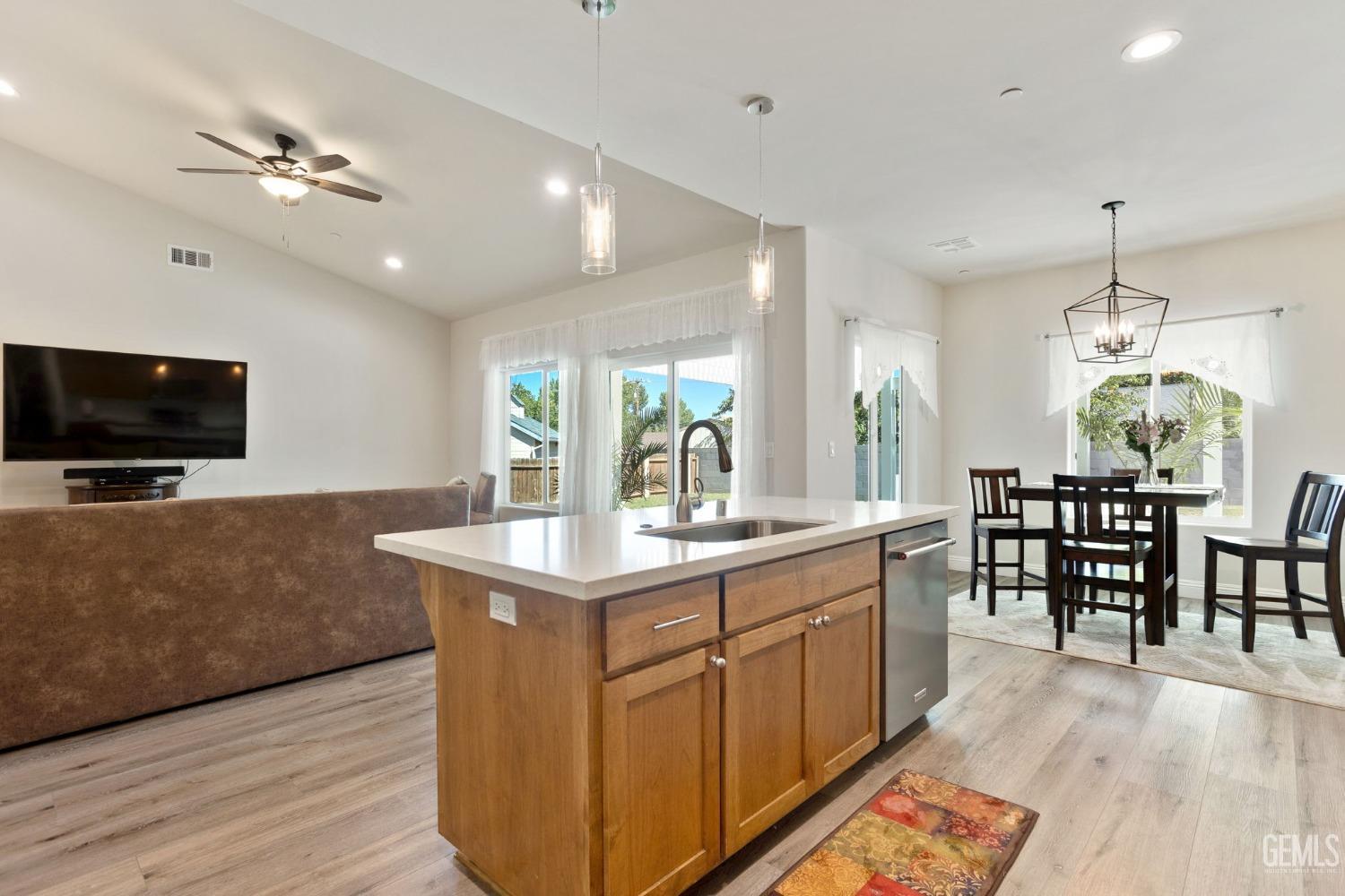 Undisclosed Address Tehachapi, CA 93561 - Photo 17 of 41 a kitchen with kitchen island stainless steel appliances a dining table chairs and flat screen tv