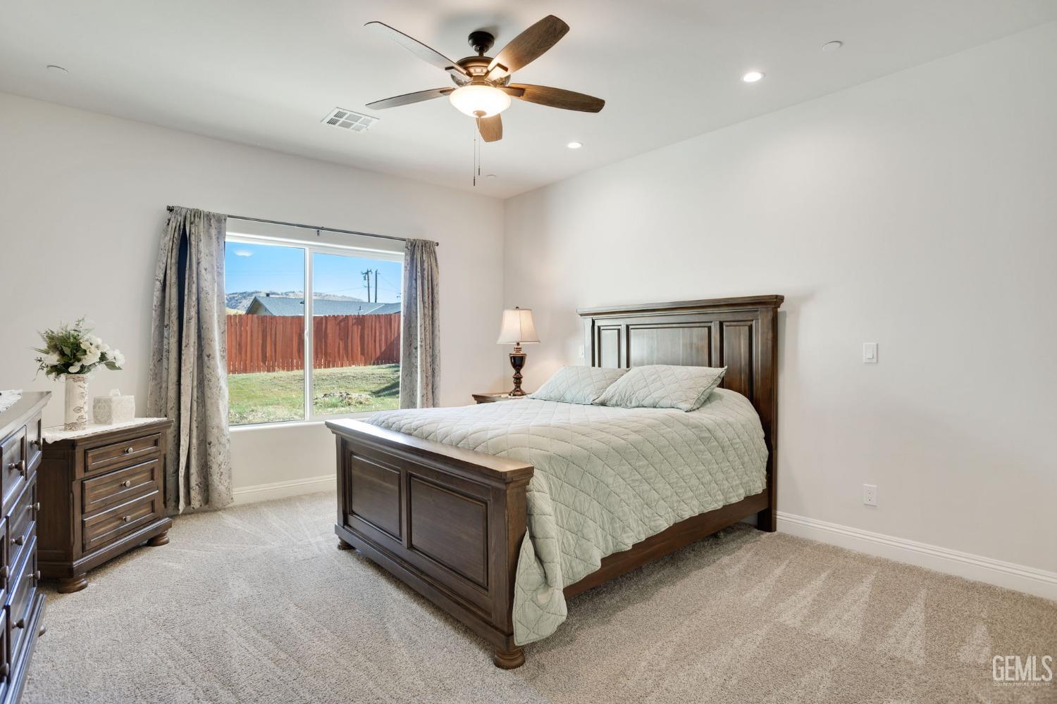 Undisclosed Address Tehachapi, CA 93561 - Photo 22 of 41 a bed room with a bed and a chandelier