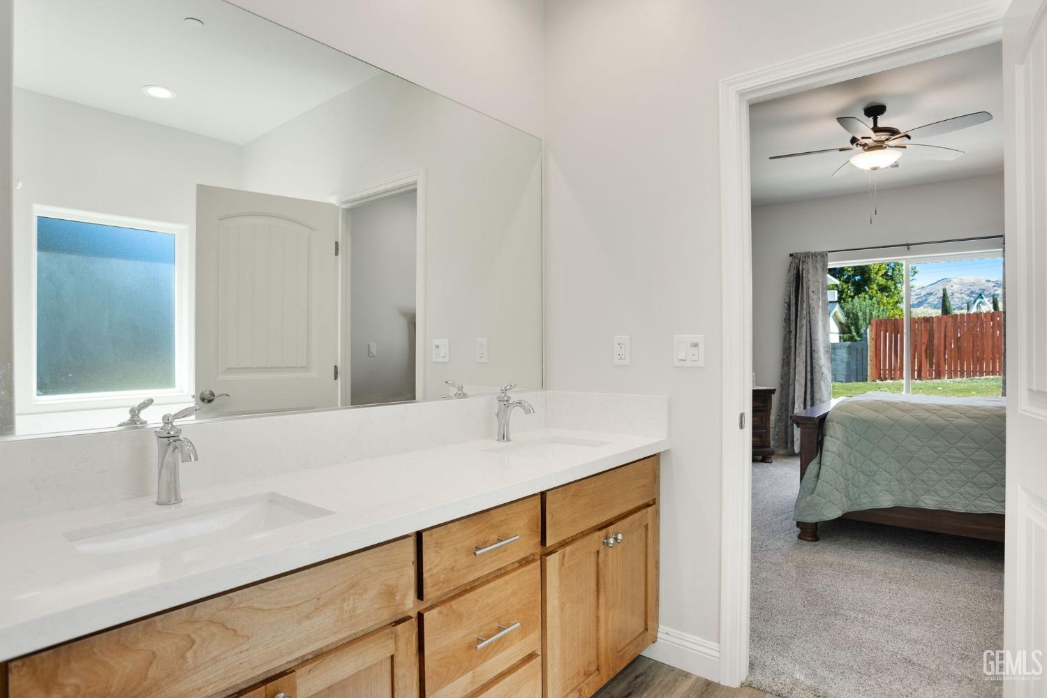 Undisclosed Address Tehachapi, CA 93561 - Photo 28 of 41 a en suite bathroom with a double vanity sink and a mirror