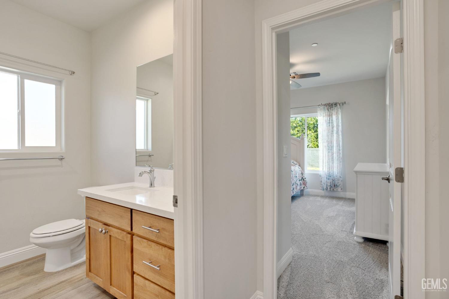 Undisclosed Address Tehachapi, CA 93561 - Photo 29 of 41 a spacious bathroom with a toilet sink and a mirror
