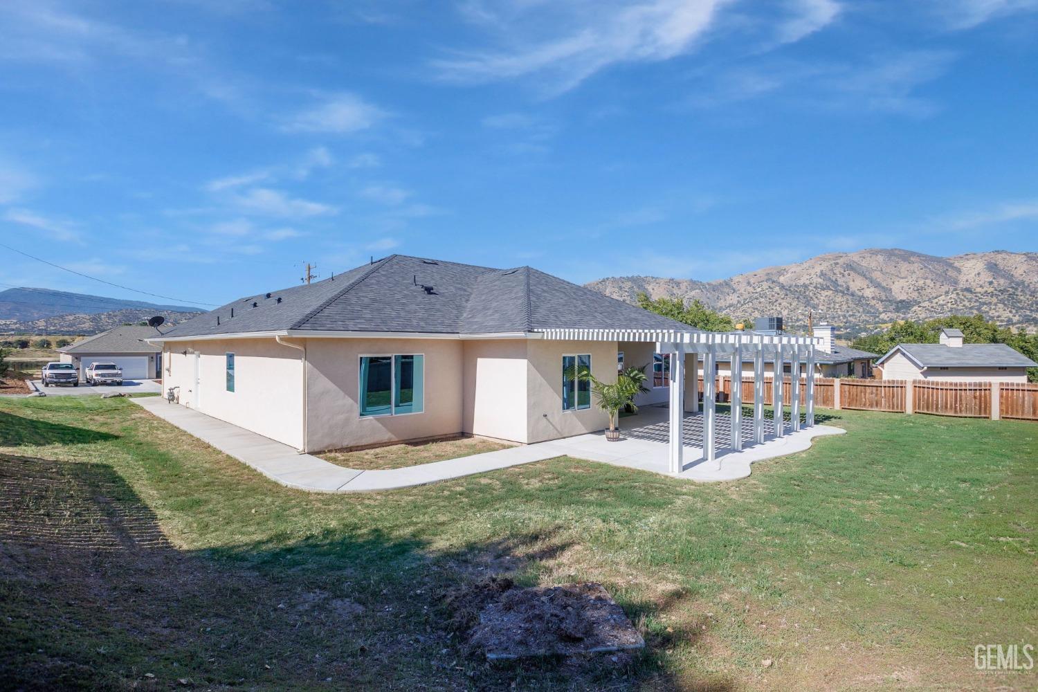 Undisclosed Address Tehachapi, CA 93561 - Photo 37 of 41 a view of a house with a yard and fence