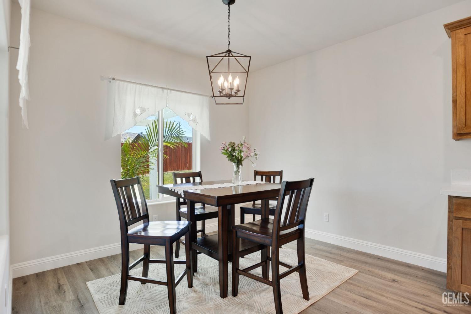 Undisclosed Address Tehachapi, CA 93561 - Photo 10 of 41 a view of a dining room with furniture window and wooden floor