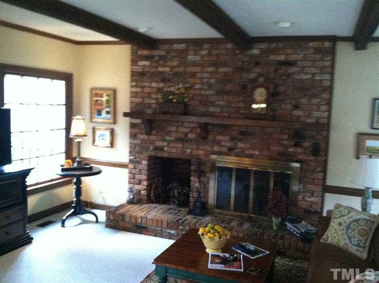 328 Sandhurst Road Raleigh, NC 27615 - Photo 3 of 3 WOOD burning FIREPLACE in family room that overlooks screen porch Family Room
