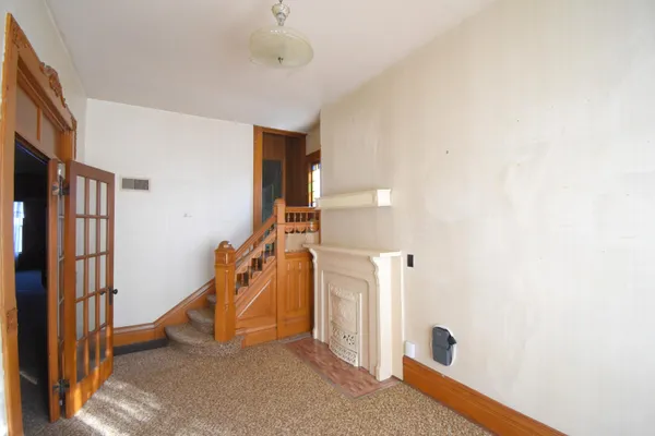 a view of an empty room with staircase