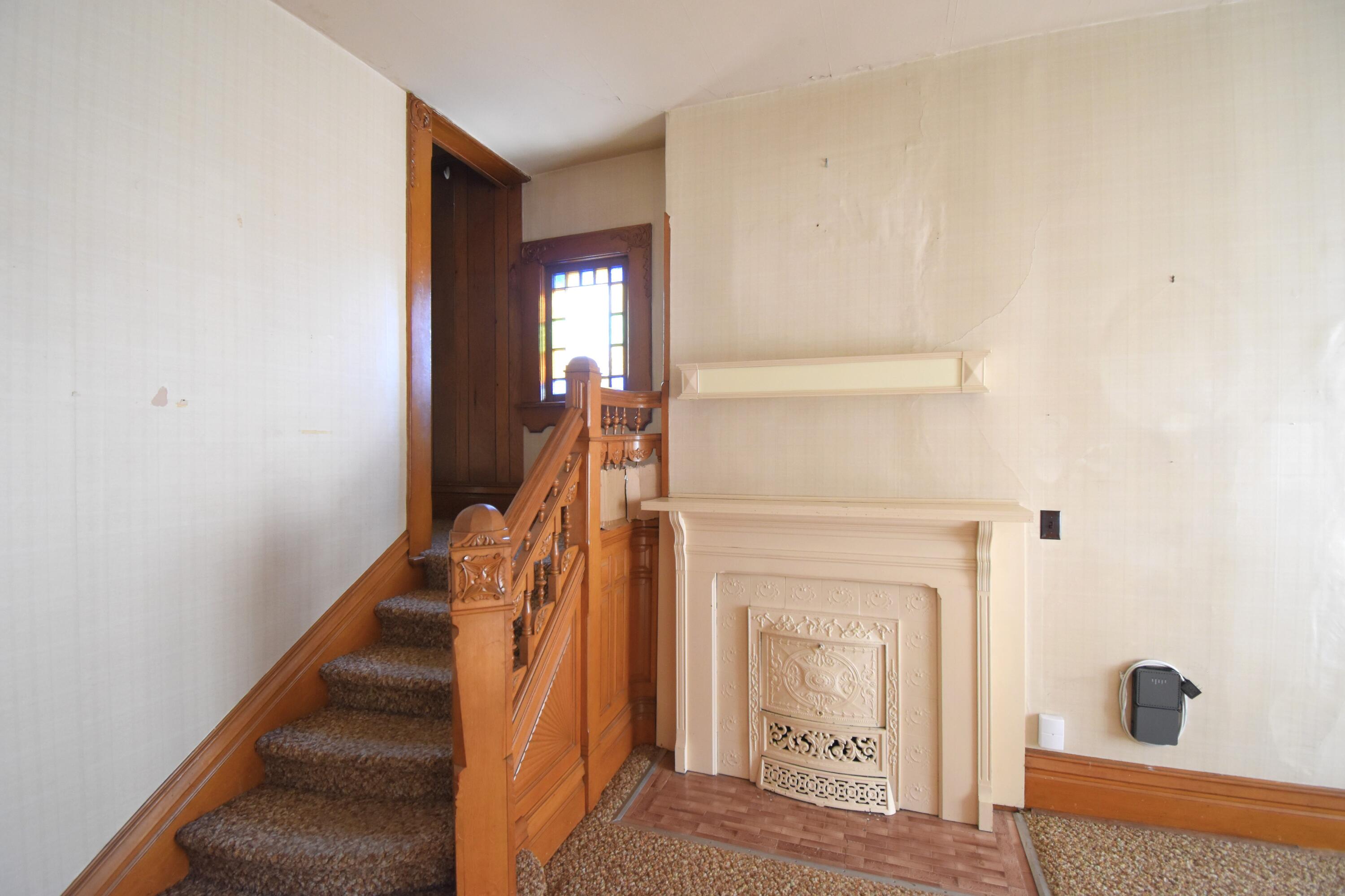 301 South Van Rensselaer Street Rensselaer, IN 47978 - Photo 13 of 42 a view of a hallway with wooden floor and staircase