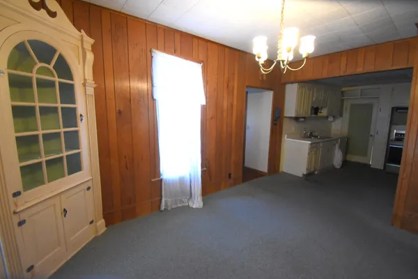 a view of a livingroom with furniture and chandelier