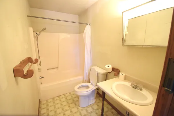 a bathroom with a sink toilet and shower
