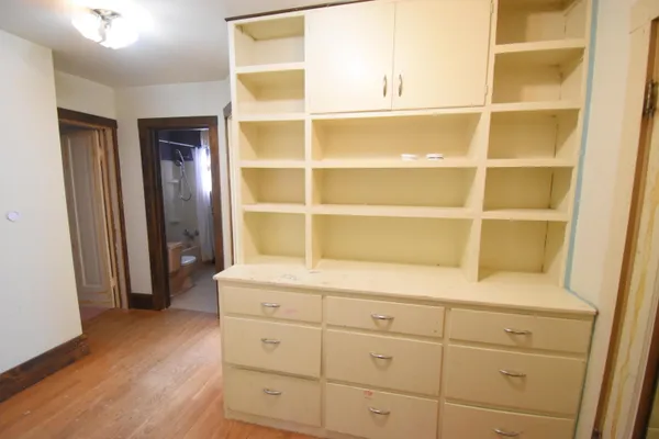 a room with a wooden closet and mirror