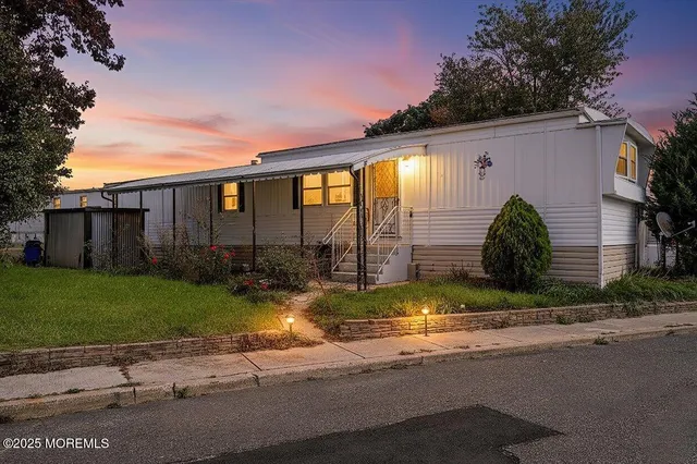 a view of backyard of house and car parked