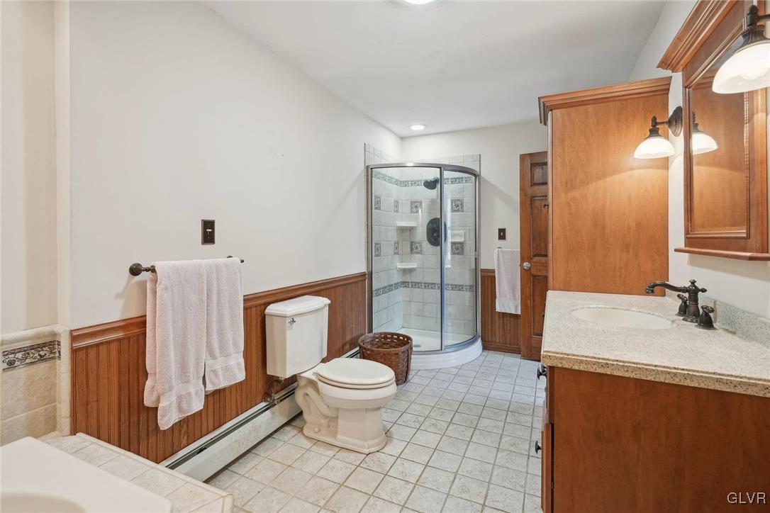 2426 Keeler Road Bath, PA 18014 - Photo 19 of 40 a bathroom with a granite countertop toilet a sink and a mirror