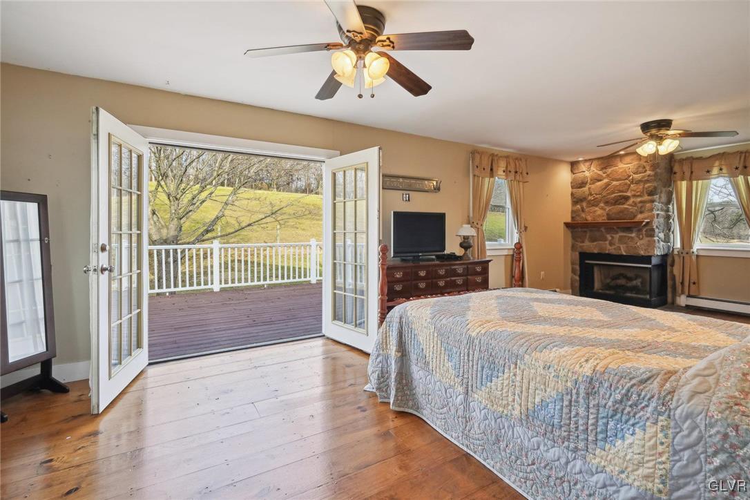 2426 Keeler Road Bath, PA 18014 - Photo 20 of 40 a spacious bedroom with a bed and a chandelier