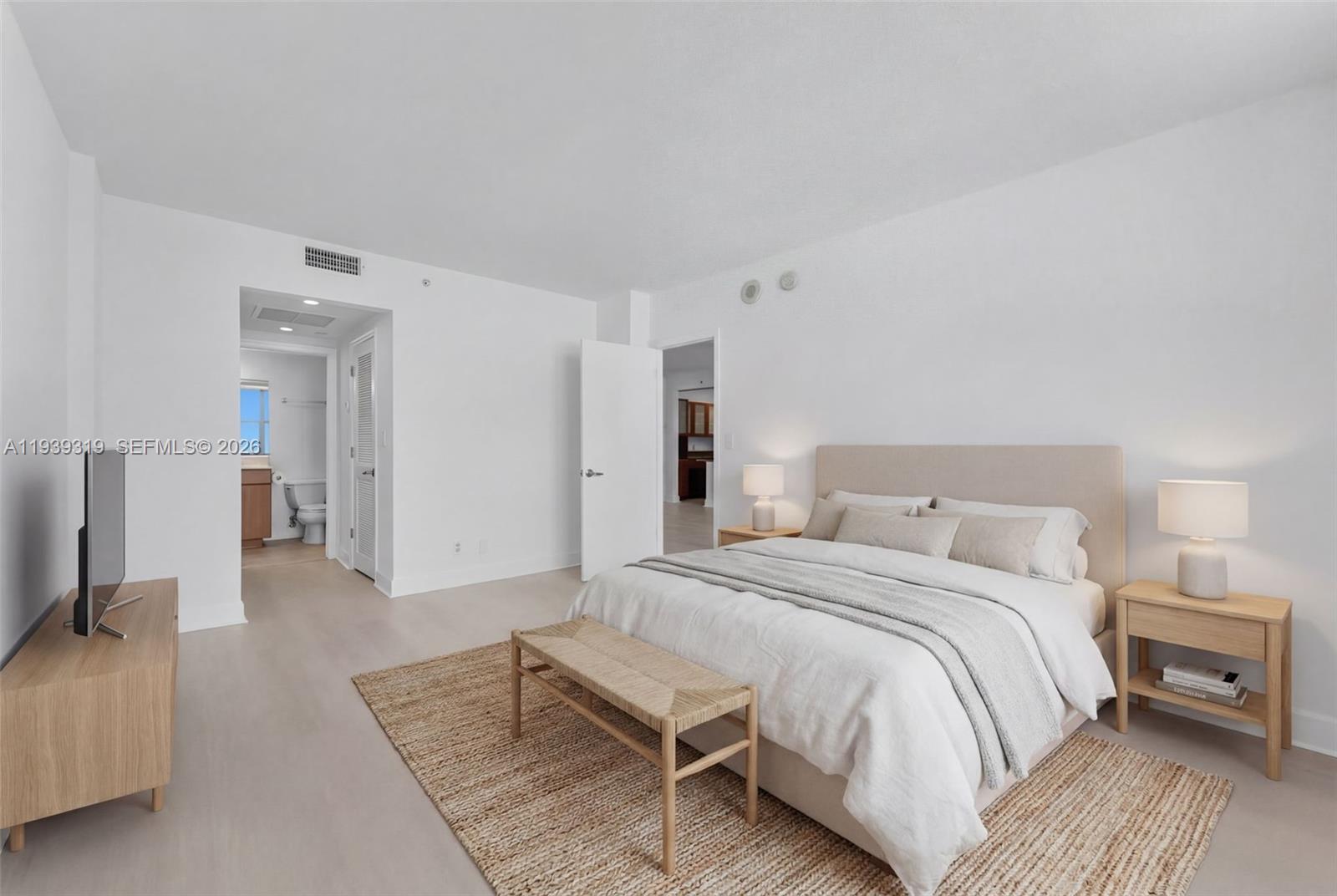 401 69th Street, Unit 1201 Miami Beach, FL 33141 - Photo 14 of 25 a spacious bedroom with a bed and a couch