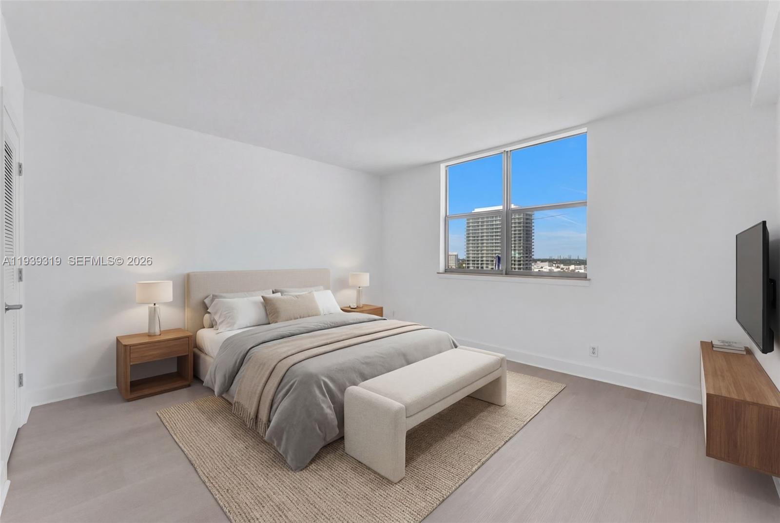 401 69th Street, Unit 1201 Miami Beach, FL 33141 - Photo 16 of 25 a bedroom with a bed and a flat screen tv