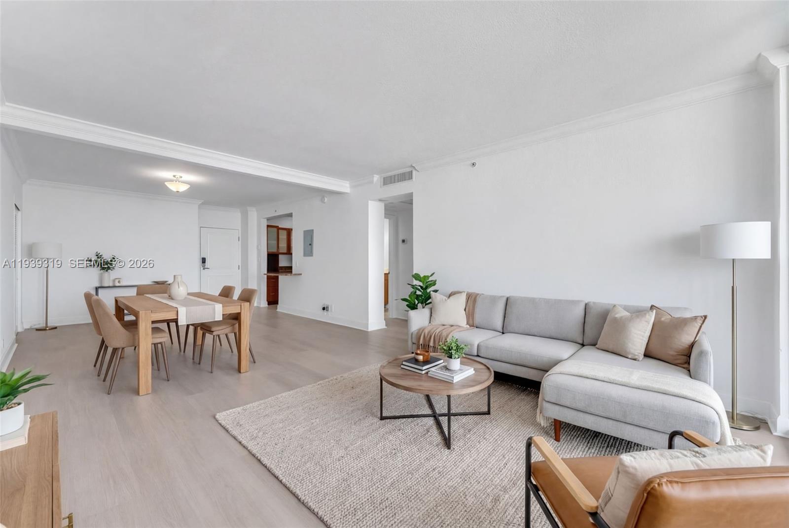 401 69th Street, Unit 1201 Miami Beach, FL 33141 - Photo 3 of 25 a living room with furniture a table and a potted plant