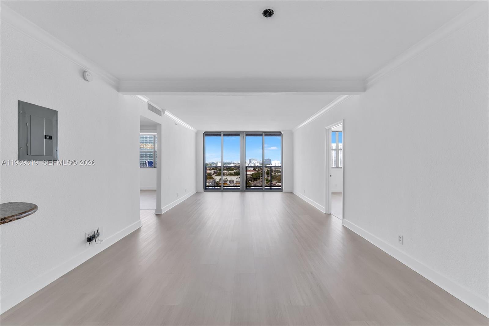 401 69th Street, Unit 1201 Miami Beach, FL 33141 - Photo 9 of 25 a view of a kitchen with furniture and a refrigerator