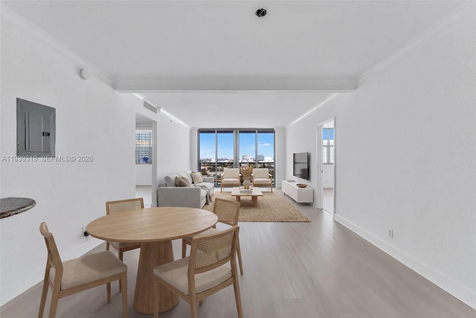 401 69th Street, Unit 1201 Miami Beach, FL 33141 - Photo 10 of 25 a view of a dining room with furniture and wooden floor