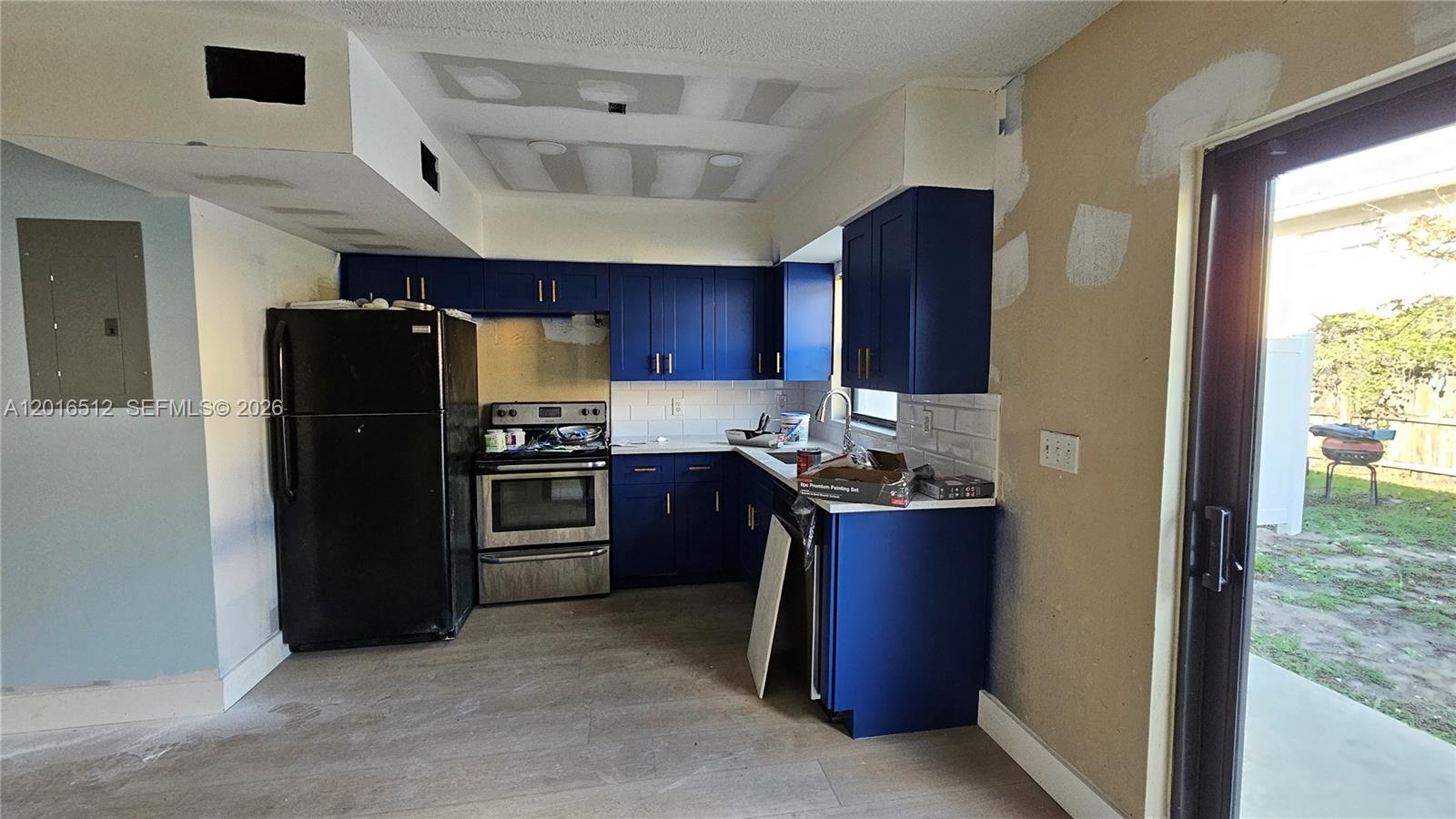 2260 Northwest 59th Way, Unit 2 Lauderhill, FL 33313 - Photo 8 of 17 a kitchen with a refrigerator and a sink