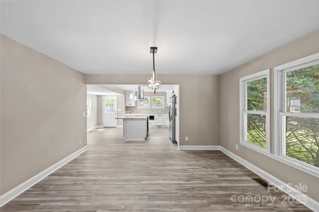 a view of a room with wooden floor water heater and a window