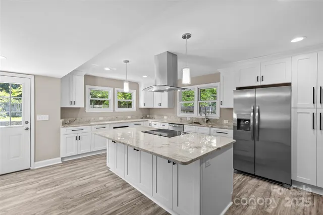 a kitchen with stainless steel appliances granite countertop a sink stove and refrigerator