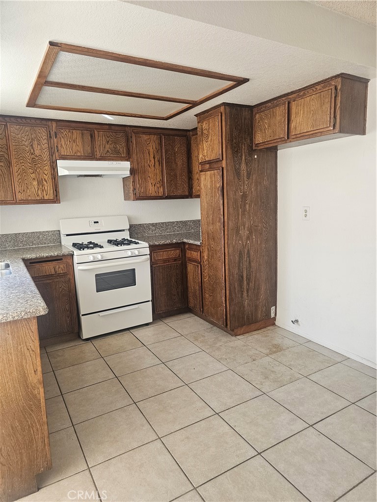 438 East Ave Q7, Unit B Palmdale, CA 93550 - Photo 6 of 26 a kitchen with a stove top oven cabinets and stainless steel appliances