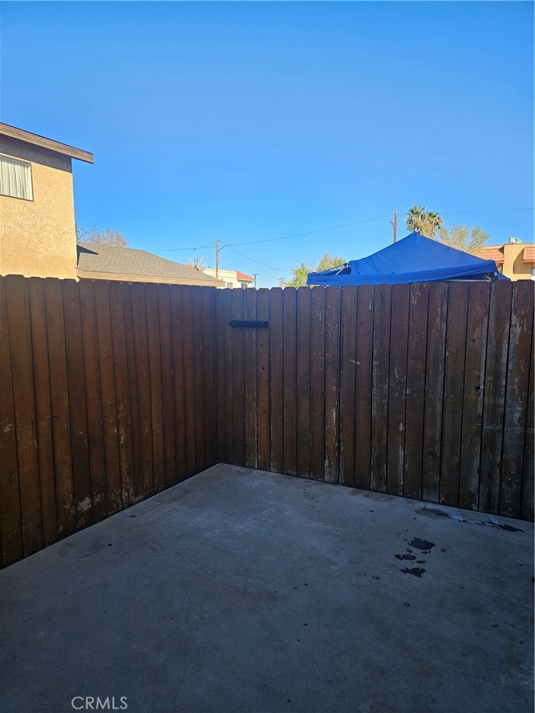 438 East Ave Q7, Unit B Palmdale, CA 93550 - Photo 9 of 26 a view of backyard with wooden fence