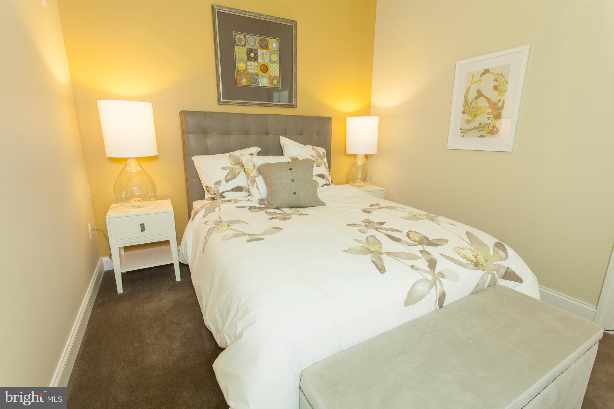 521 St Paul Street, Unit 3BR Baltimore, MD 21202 - Photo 26 of 44 a bed sitting in a bedroom next to a lamp