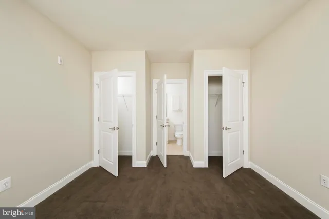 a bathroom with a granite countertop toilet a sink and a bathtub