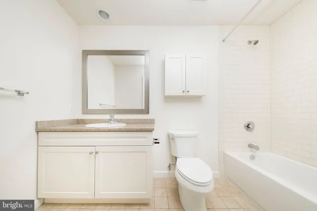 a view of a kitchen with a sink and a refrigerator