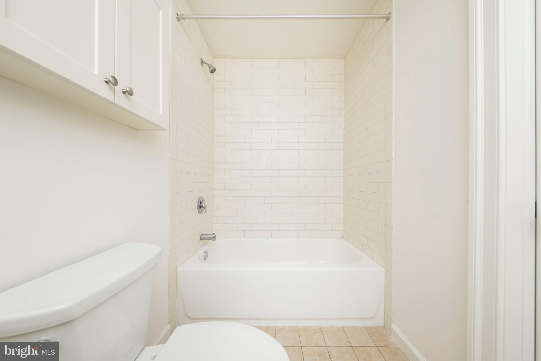 521 St Paul Street, Unit 3BR Baltimore, MD 21202 - Photo 39 of 44 a bathroom with a bathtub and a toilet