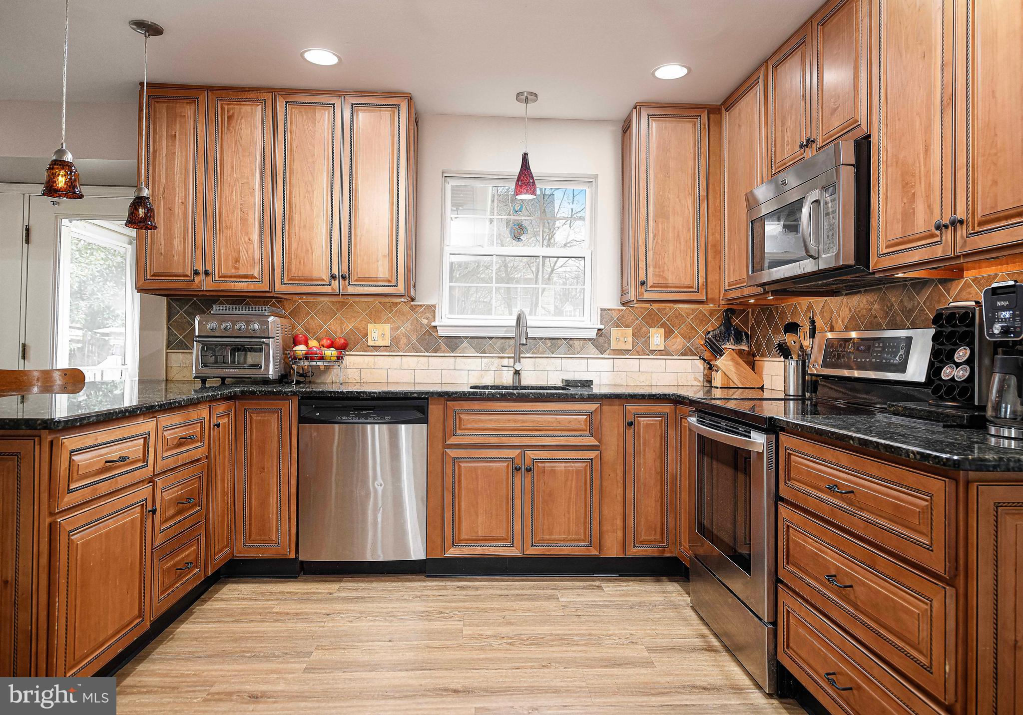 402 Hall Street Bel Air, MD 21014 - Photo 3 of 46 a kitchen with stainless steel appliances granite countertop a sink stove and cabinets
