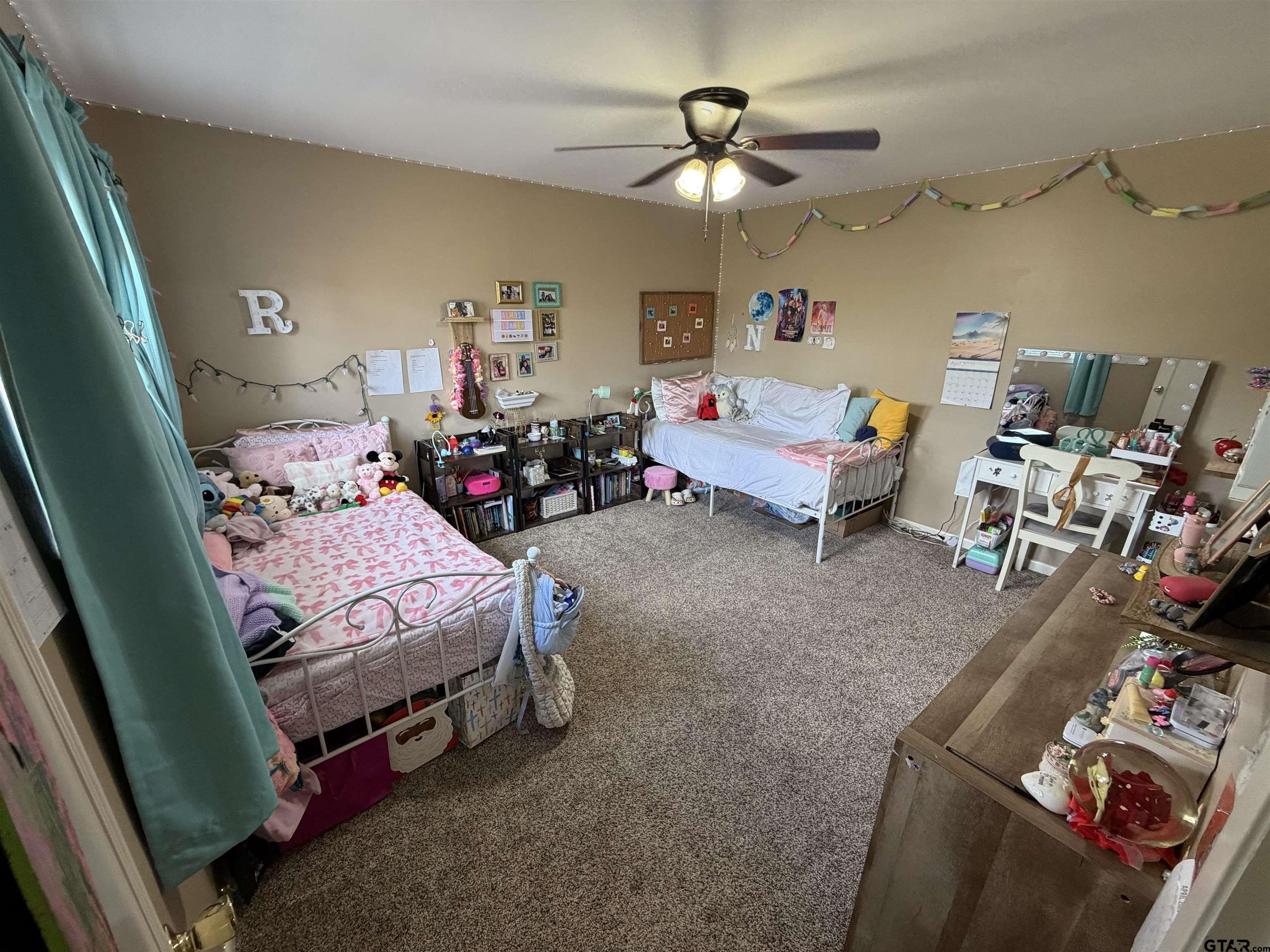 5704 Foxcroft Road Tyler, TX 75703 - Photo 9 of 10 a bedroom with furniture and a chandelier