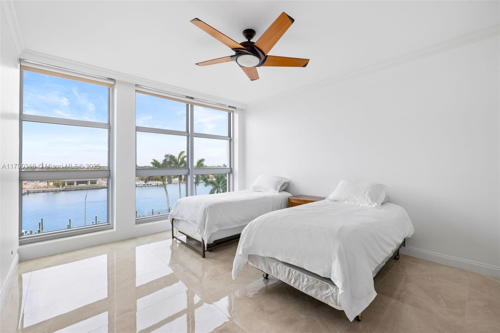 5055 Collins Avenue, Unit 6M Miami Beach, FL 33140 - Photo 11 of 40 a bedroom with two beds and next to a window