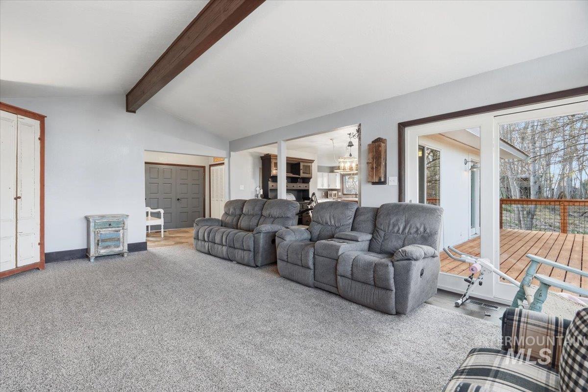 7771 Elmore Road Fruitland, ID 83619 - Photo 4 of 45 Living room featuring vaulted ceiling with beams and carpet floors