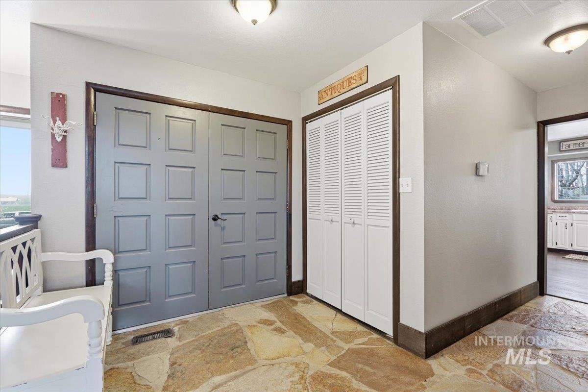 7771 Elmore Road Fruitland, ID 83619 - Photo 44 of 45 Foyer featuring stone flooring and baseboards