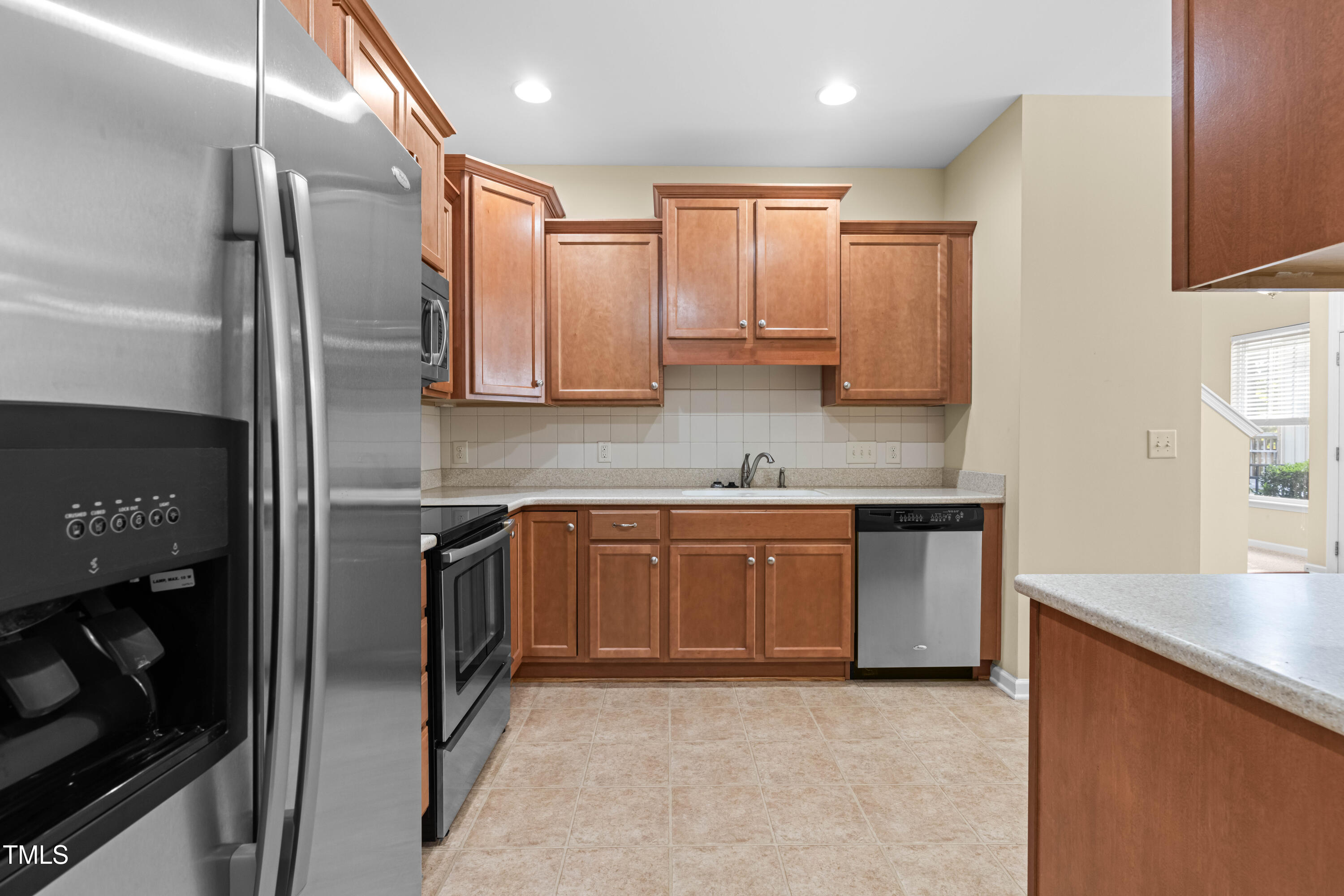 1305 Silver Beach Way Raleigh, NC 27606 - Photo 13 of 47 a kitchen with stainless steel appliances granite countertop a sink refrigerator and cabinets
