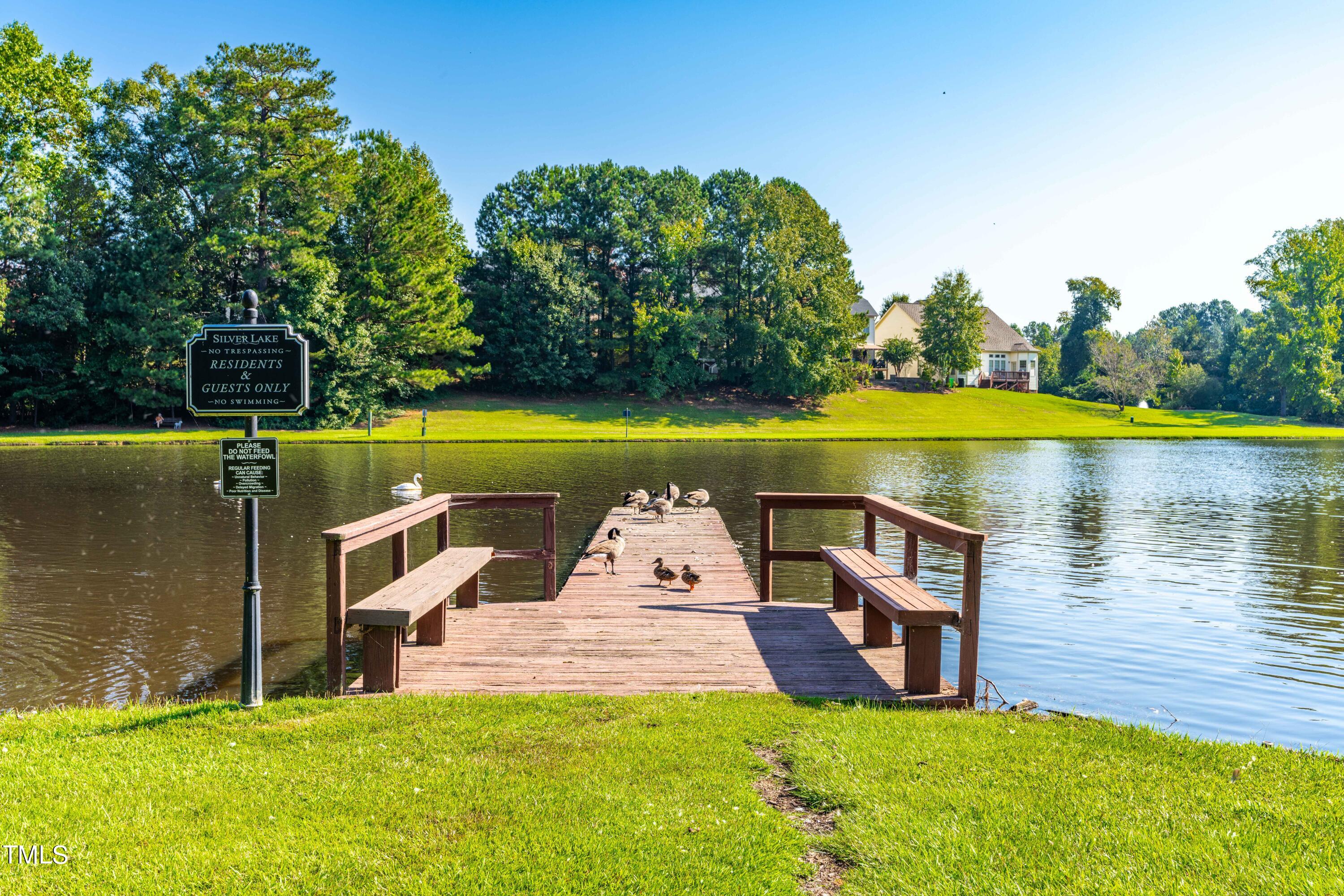 1305 Silver Beach Way Raleigh, NC 27606 - Photo 32 of 47 a view of a lake with a house in the background