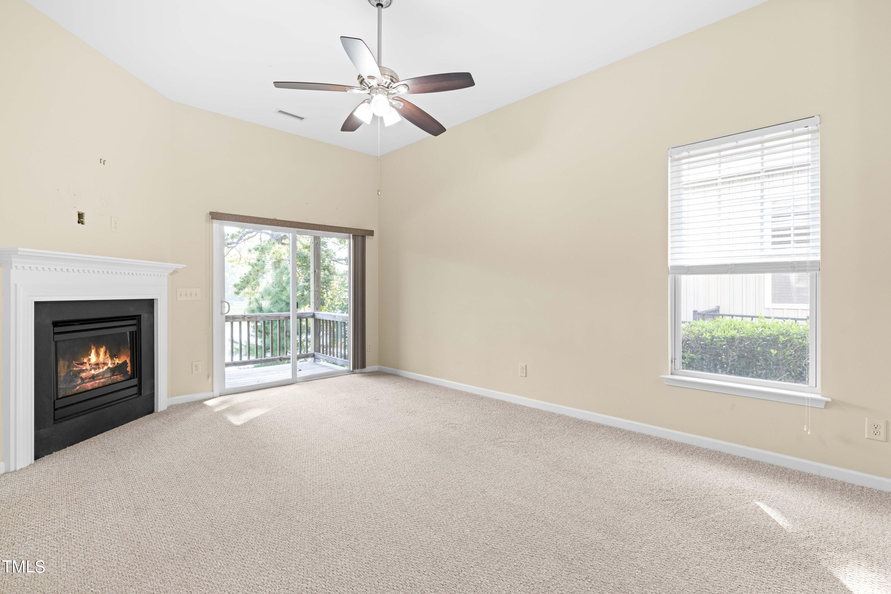 1305 Silver Beach Way Raleigh, NC 27606 - Photo 6 of 47 an empty room with windows and fireplace
