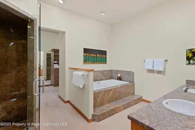a en suite bathroom with a granite countertop sink and a mirror