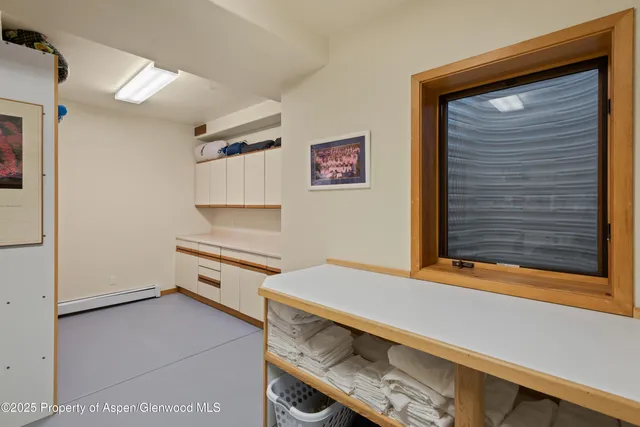 a kitchen with white cabinets and a stove