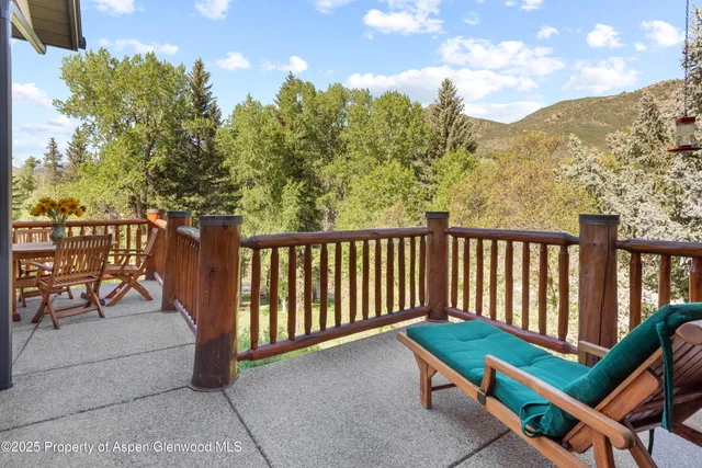 a view of backyard with swimming pool and trees