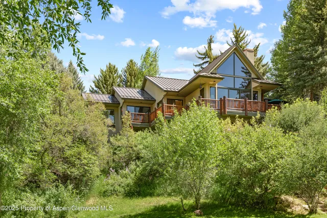 a view of a backyard with plants and a fire pit