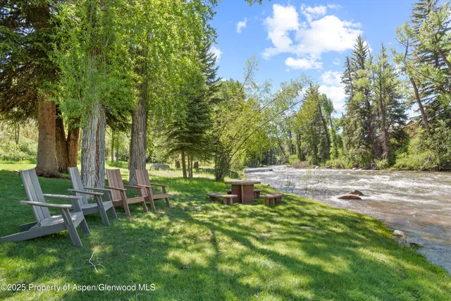 a backyard of a house with table and chairs