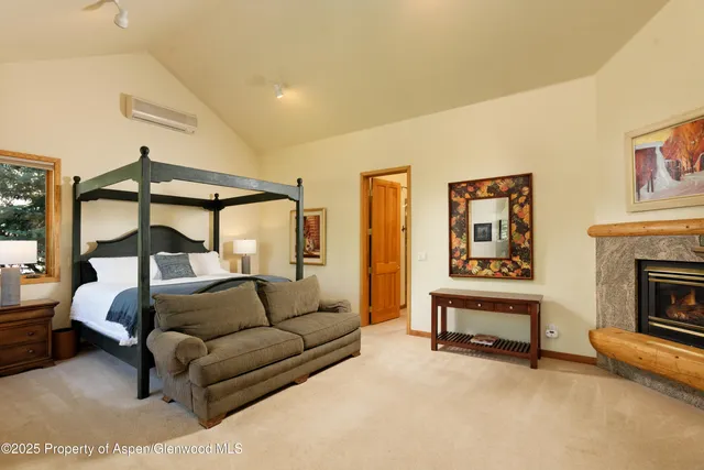 a bedroom with furniture and a fireplace