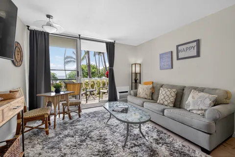 a bedroom with furniture and a flat screen tv